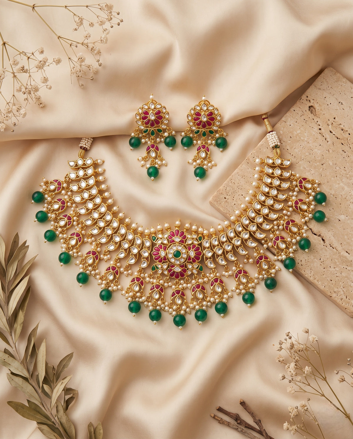 Jadtar Kundan choker necklace with emerald drops and matching earrings styled on satin – Studio Gulabi