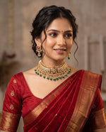 Woman wearing jadtar Kundan choker necklace with emerald drops and matching earrings – Studio Gulabi