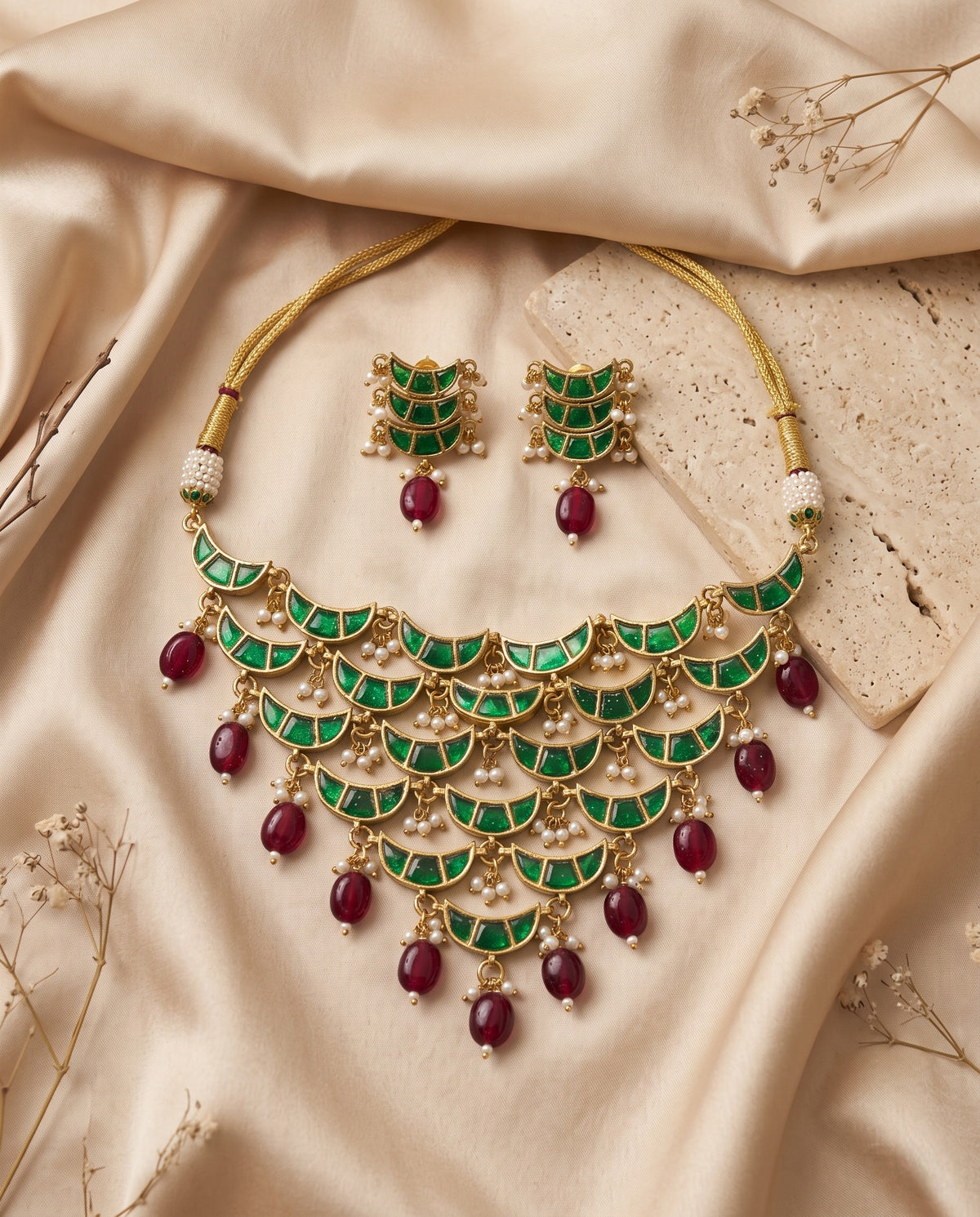 Jadtar moti festive necklace set with green stones, ruby drops and matching earrings styled on satin – Studio Gulabi