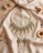 Jadtar and moti choker necklace set with green drops and matching earrings styled on satin – Studio Gulabi
