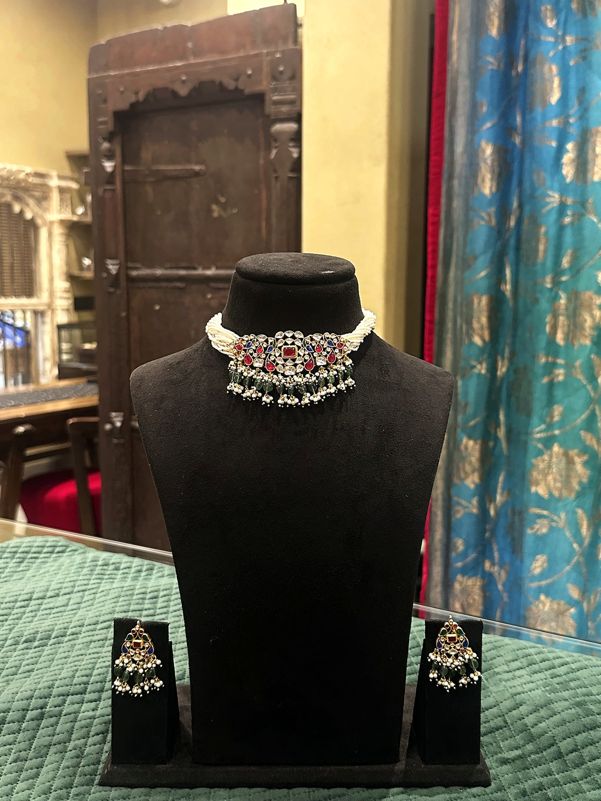 Kundan moti mala choker with ruby and emerald drops and matching earrings on black velvet bust – Studio Gulabi 926ADI191